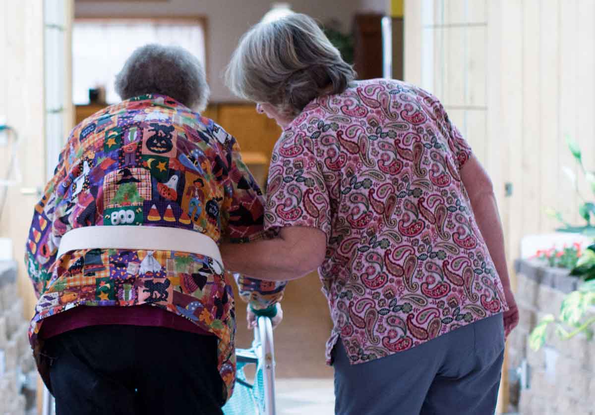 Rose Haven Assisted Living resident walking with nurse