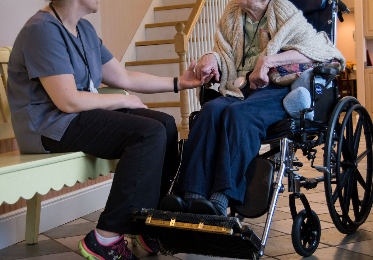 rose haven assisted living nurse holding hand of resident